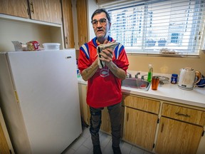 Michel Domaine dries his hands while standing in front of a kitchen sink