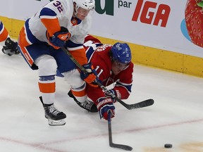 Canadiens' Brendan Gallagher dives towards puck while battling with Islanders defenceman Adam Pelech during second period Thursday night.