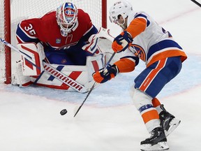 Canadiens goaltender Samuel Montembeault is down on his pads and eyeing the puck just before stopping Islanders' Kyle Palmieri in close during game last week at the Bell Centre.