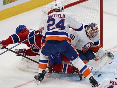 Montreal Canadiens' Cole Caufield falls beside the Islanders net