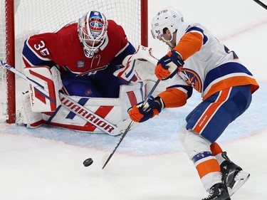 New York Islanders' Kyle Palmieri handles the puck in front of Montreal Canadiens goaltender Sam Montembeault