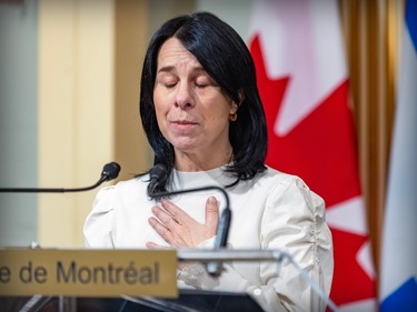 Valérie Plante closes her eyes and puts her hand to her chest while speaking at a podium