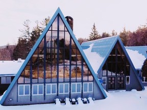 Triangular buildings in a wooded area covered in snow