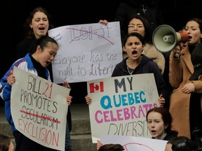 Protesters at a rally against Bill 21 hold signs reading Bill 21 Promoters Exclusion, Everyone Has the Right to Liberty, and My Quebec Celebrates Diversity.
