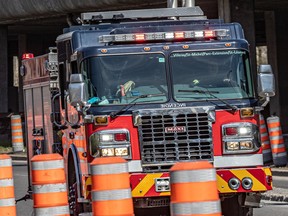 A Montreal fire truck navigates a street under construction.