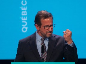 Photo shows Bloc Québécois Leader Yves-François Blanchet pumping his fist at a lectern.