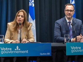Higher Education Minister Pascale Déry and French Language Minister Jean-François Roberge sit at a table behind a sign reading Votre Gouvernement.