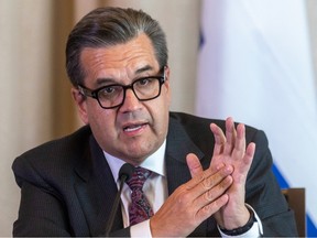 Denis Coderre puts his hands together while speaking