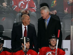 Head coach Jacques Lemaire, left, and assistant coach Larry Robinson confer behind the New Jersey Devils bench in 2011.