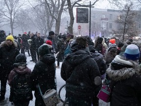 People gather early morning on Friday, Dec. 16, 2022 at Parc des Royaux in Montreal to commemorate seven year-old Maria Legenkovska.