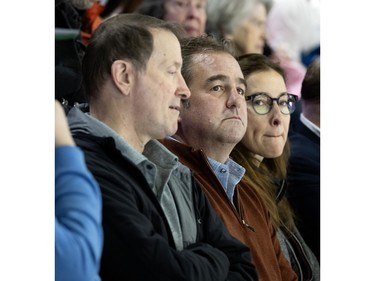 Geoff Molson and Louis Vachon, left, of National Bank, watch the PWHL home opener at the Verdun Auditorium in Montreal on Saturday, Jan. 13, 2024.