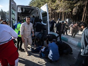 Iranian emergency services arrive at the site where two explosions in quick succession struck a crowd marking the anniversary of the 2020 killing of Guards general Qasem Soleimani.