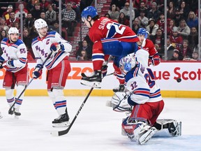 of the Montreal Canadiens jumps over goaltender Jonathan Quick
