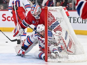 New York Rangers' Jonny Brodzinski crashes into Canadiens goaltender Sam Montembeault at the Bell Centre on Saturday, Jan. 6, 2024, in Montreal.