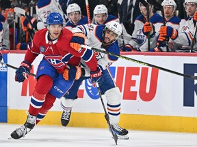 Canadiens defeceman Johnathan Kovacevic, left, and Oilers' Evander Kane jostle for position during game last week at the Bell Centre.