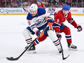 Edmonton Oilers' Zach Hyman (18) skates the puck against Canadiens' Mike Matheson at the Bell Centre on Saturday, Jan. 13, 2024, in Montreal.