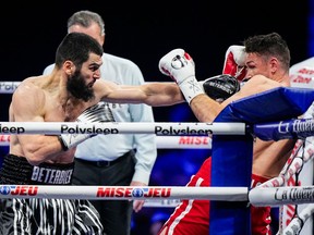 Artur Beterbiev of Montreal punches Callum Smith of the United Kingdom during a boxing match.