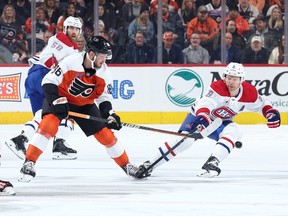 Joel Farabee #86 of the Philadelphia Flyers and Mike Matheson #8 of the Montreal Canadiens challenge for the puck