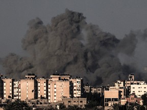 Smoke billows over Khan Yunis in the southern Gaza Strip during Israeli bombardment.