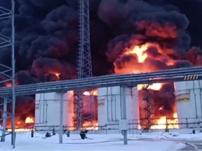 Rescuers work to extinguish a fire at the oil depot following a drone attack in Klintsy, Bryansk region.