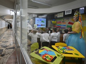 Kindergarten staff supervise children at an underground subway passage transformed into a kindergarten, in Kharkiv on Saturday, Jan. 20, 2024, amid the Russian invasion of Ukraine.