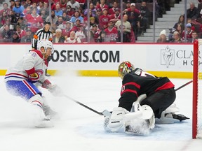 Joonas Korpisalo #70 of the Ottawa Senators makes a pad save against Mike Matheson #8 of the Montreal Canadiens