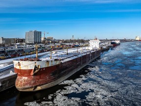 A cargo ship at port in an icy river.