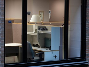 An empty cubicle seen through a window.