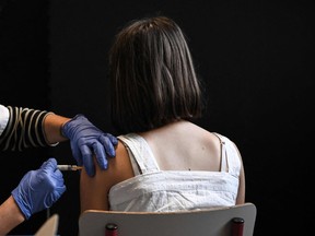 A schoolgirl receives a vaccine injection during a vaccination campaign against the papillomavirus (HPV infection) at the Jean Moulin Middle School in Le Bouscat, southwestern France, on October 5, 2023.