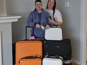 Meagan Watson, left, and her wife, Mindy, with luggage.
