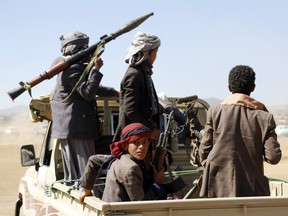 Houthi fighters and tribesmen stage a rally against the U.S. and the U.K. strikes on Houthi-run military sites near Sanaa, Yemen, on Sunday, Jan. 14, 2024.