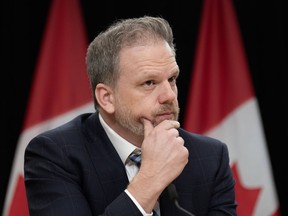 Federal Health Minister Mark Holland listens to a question from a reporter during a news conference, Tuesday, Dec. 12, 2023 in Ottawa.