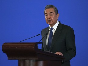 Chinese Foreign Minister Wang Yi delivers his opening keynote address for a seminar on International Situation and China's Diplomacy held at the Diaoyutai State Guest House in Beijing, Tuesday, Jan. 9, 2024.
