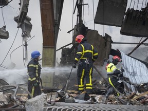 Firefighters put out a fire after a Russian rocket attack in Kyiv, Ukraine, Wednesday, Aug. 30, 2023.