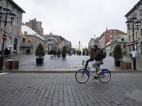 People walk on the snowless streets of Place Jacques Cartier in Old Montreal, Wednesday, Jan. 3, 2024.