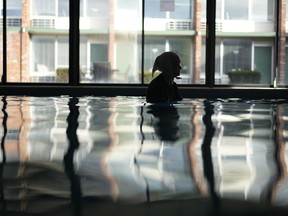 An Amish woman from Ohio is silhouetted as she swims among Tesla BioHealing generators at Tesla BioHealing's Tesla Wellness Hotel and MedBed Center.