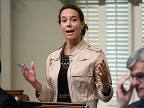 A woman gestures during a press conference.