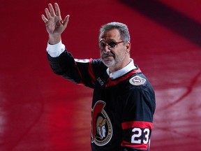 New Senators owner Michael Andlauer is seen waving to fans wearing a Sens jersey during Ottawa's first home game this season.