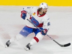 Rocket centre Philippe Maillet is seen in the Rocket's home white uniform making a sharp turn with his stick in his hand.