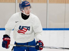 Canadiens defence prospect Lane Hutson is seen wearing his Team USA jersey and holding his stick in his hands.