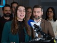 Emilise Lessard-Therrien speaks at a podium with Gabriel Nadeau-Dubois beside her and other QS MNAs behind