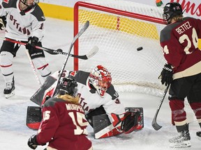 Montreal's Maureen Murphy scores against Ottawa goaltender Emerance Maschmeyer as Montreal's Ann-Sophie Bettez looks on.