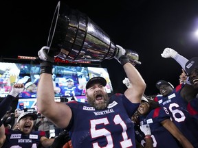 Montreal Alouettes' Kristian Matte (51) hoists the Grey Cup as the Alouettes celebrate defeating the Winnipeg Blue Bombers in the 110th CFL Grey Cup in Hamilton, Ont., on Sunday, November 19, 2023. The Canadian offensive lineman is returning for a 14th season with the Alouettes.