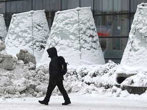 A man walks on the street in freezing temperatures in Helsinki, Wednesday, Jan. 3, 2024.