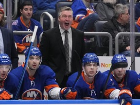 Patrick Roy yells standing behind the Islanders bench