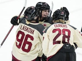 Marie-Philip Poulin, Sarah Nurse, Hilary Knight, Kendall Coyne Schofield and Taylor Heise headline the two dozen women named to the NHL all-star festival's three-on-three tournament. Poulin, centre, celebrates with Montreal teammates Dominika Laskova, left, and Catherine Dubois, right, after scoring an empty-net goal during the third period of a PWHL hockey game against New York, in Elmont, N.Y., Wednesday, Jan. 10, 2024.