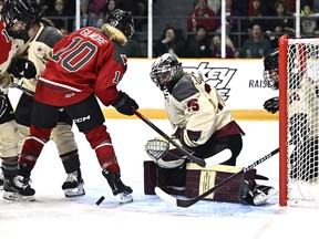 The puck bounces by the skate of Ottawa's Becca Gilmore as Montreal goalie Ann-Renée Desbiens watches, while Dominika Laskova (96) defends.