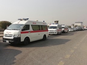 Ambulances line up in front of a headquarters of the Popular Mobilization Force after it was hit by an airstrike in Baghdad, Iraq, Thursday, Jan. 4, 2024. The Popular Mobilization Force - a coalition of militias that is nominally under the control of the Iraqi military - announced in a statement that its deputy head of operations in Baghdad, Mushtaq Taleb al-Saidi, or "Abu Taqwa," had been killed in the strike.