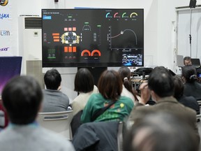 Journalists watch a live streaming of the pinpoint moon landing operation by the Smart Lander for Investigating Moon (SLIM) spacecraft at JAXA's Sagamihara Campus Saturday, Jan. 20, 2024, in Sagamihara near Tokyo.