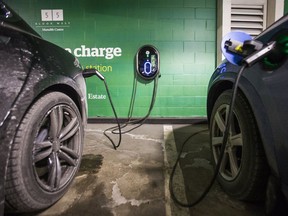 Two electric vehicles charging at the parking lot under the Manulife Centre in Toronto, 2018.